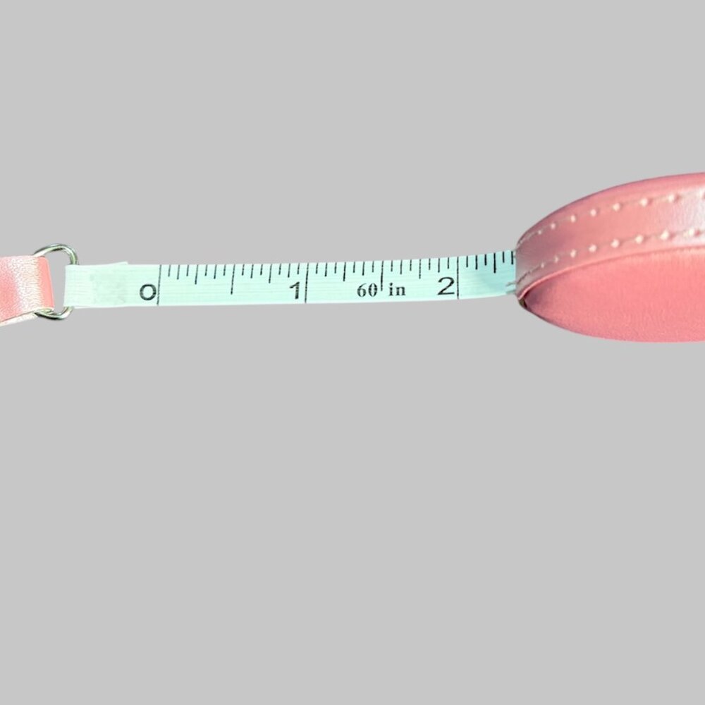 TAPE MEASURE IN A SOFT FAUX LEATHER ROUND CASE THAT EASILY RETRACTS